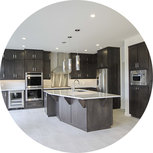 A kitchen with dark cabinets and white tile floors.