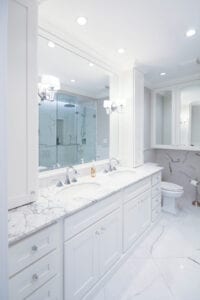 A white bathroom with his and hers vanity sink