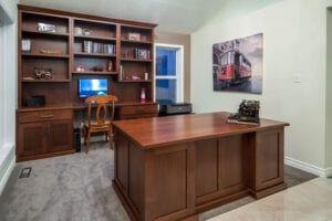 An office area with a customized desk and bookshelf